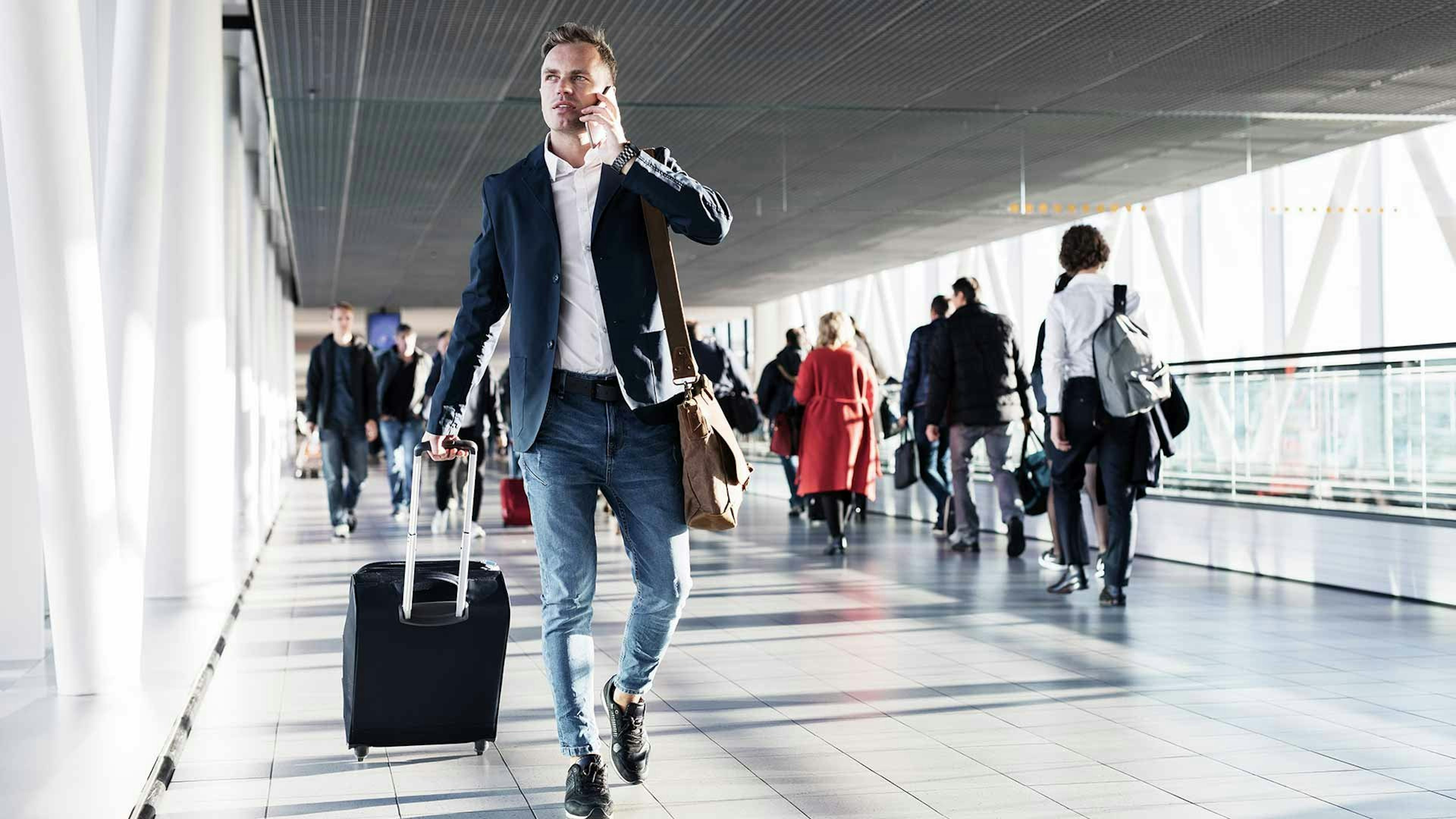 Business man walking through airport