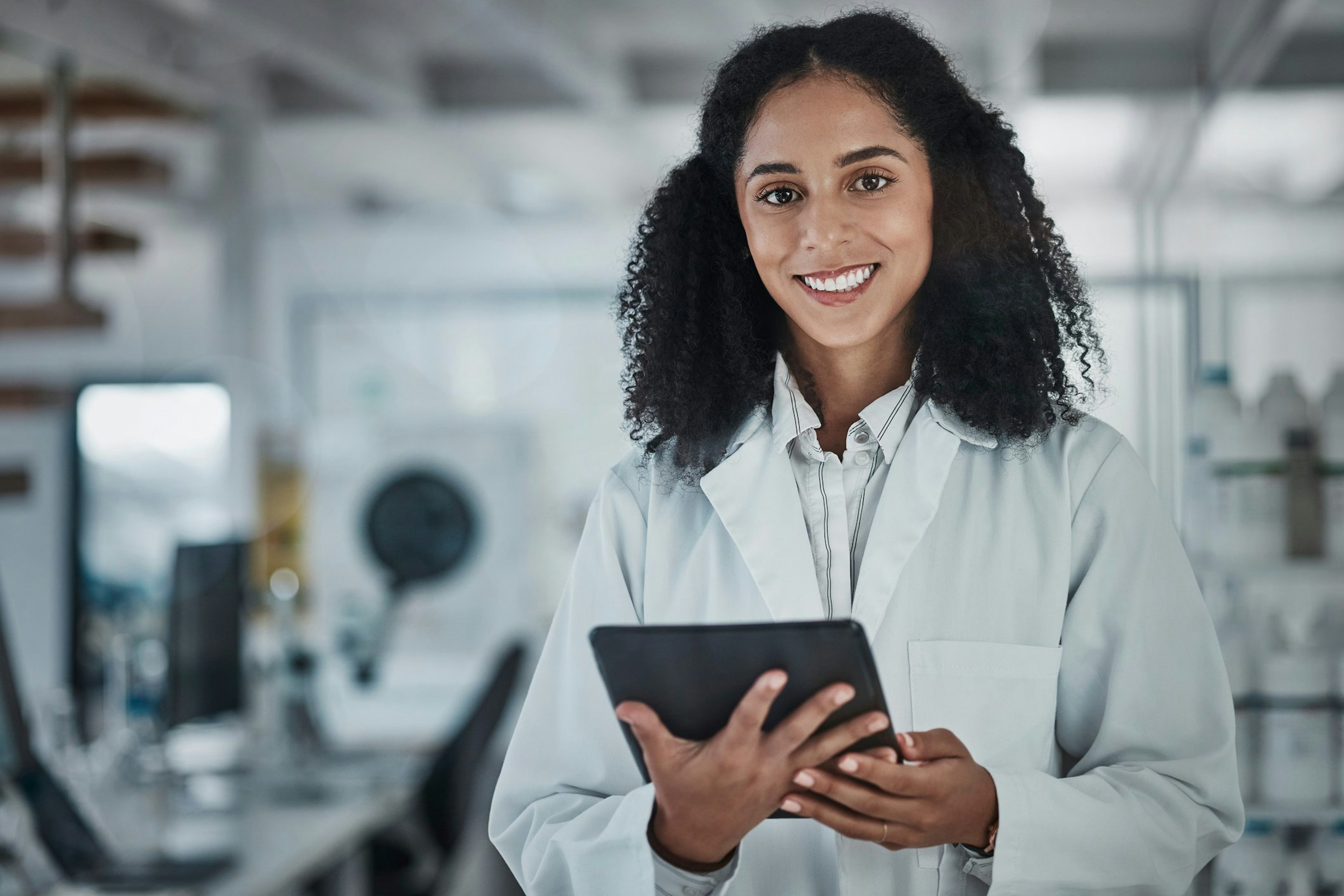 RD Engineer smiles while holding a tablet